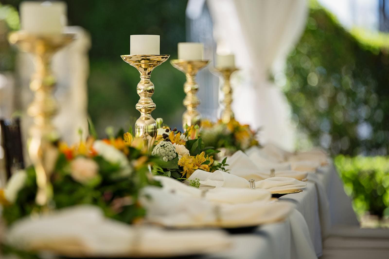 Gold candlesticks and lush garland table decoration